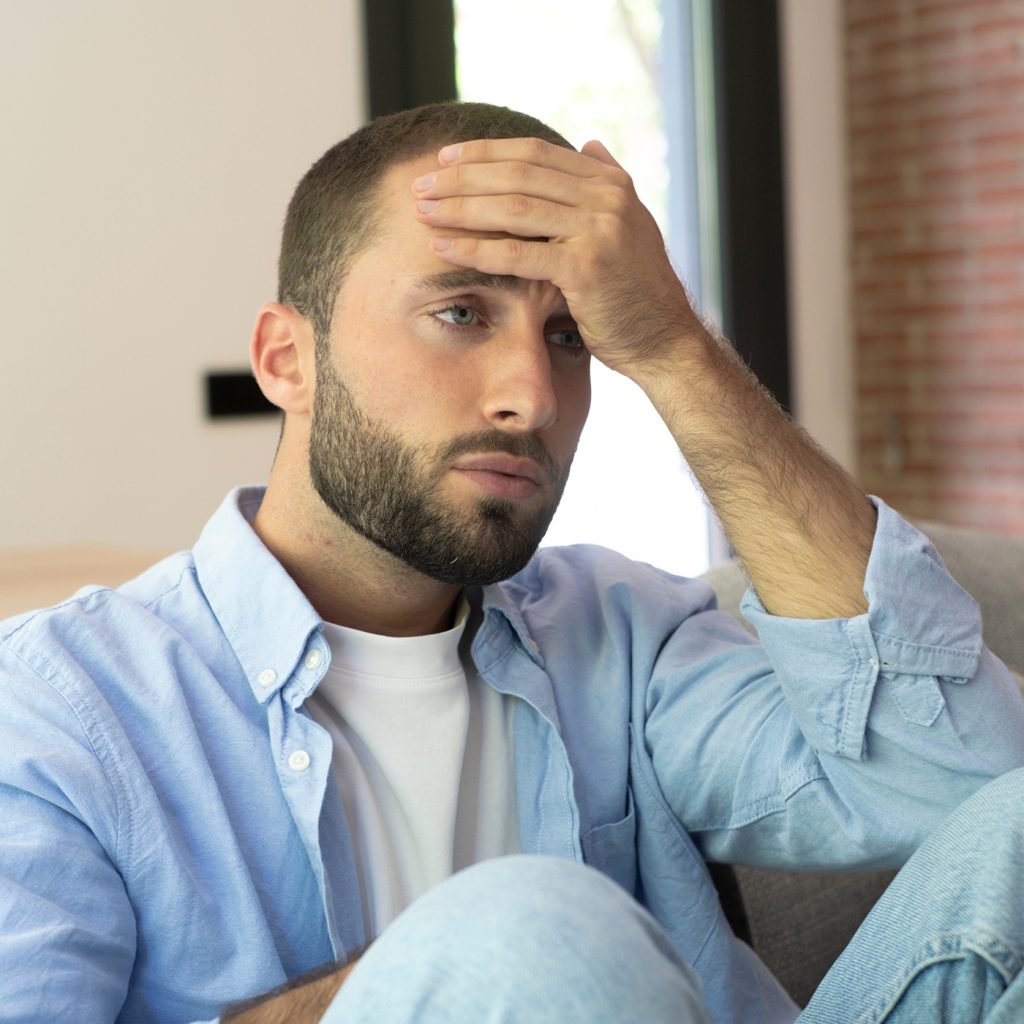 New Home Page 4 Stressed young man holding his forehead, nervous system overload